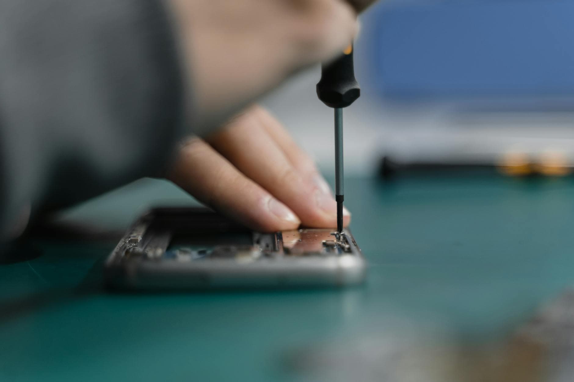 Technician repairing a phone at a workbench